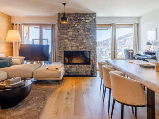 Experience luxury living in this stunning property, featuring a cozy fireplace and a spacious living area.