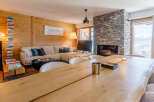 Experience luxury living in this stunning property, featuring a cozy living room with a fireplace and a spacious dining area.