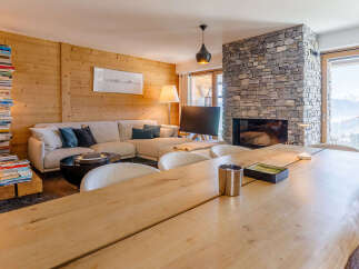 Experience luxury living in this stunning property, featuring a cozy living room with a fireplace and a spacious dining area.