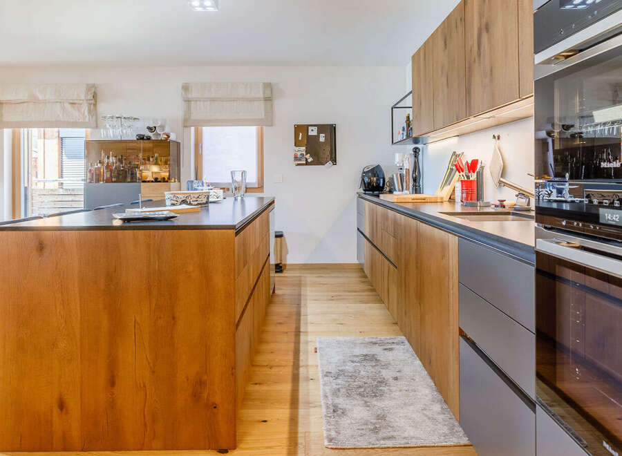 This stunning kitchen boasts a modern design with sleek wooden cabinetry and a spacious island.