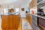 This stunning kitchen boasts a modern design with sleek wooden cabinetry and a spacious island.