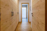 Explore the warmth of this inviting hallway, featuring stunning wooden paneling that extends throughout.