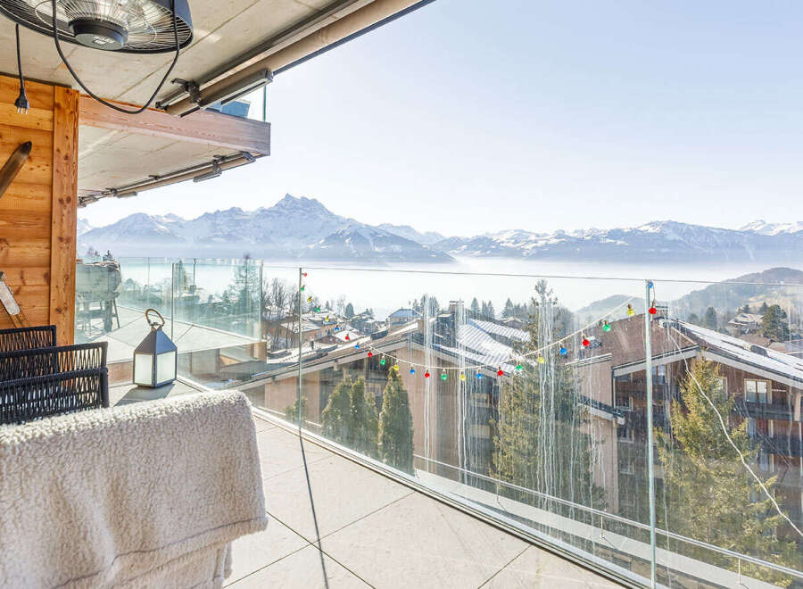 Enjoy breathtaking mountain views from this luxurious balcony.