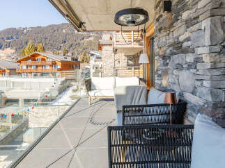 Enjoy breathtaking mountain views from this luxurious balcony.