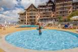 This stunning resort boasts a beautiful outdoor pool area perfect for families, featuring both a large pool and a separate paddling pool for younger children.