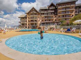This stunning resort boasts a beautiful outdoor pool area perfect for families, featuring both a large pool and a separate paddling pool for younger children.