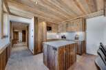 This stunning chalet boasts a rustic-chic kitchen with reclaimed wood cabinetry and a granite island, perfect for culinary adventures.
