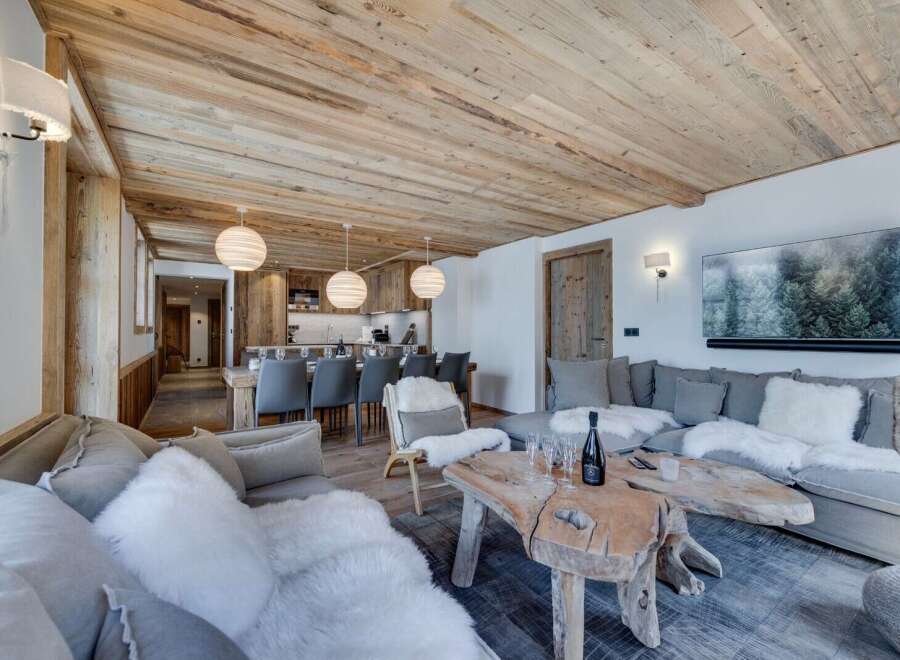 This stunning chalet boasts a spacious open-plan living area with a cozy fireplace, perfect for relaxing after a day on the slopes.