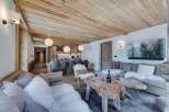 This stunning chalet boasts a spacious open-plan living area with a cozy fireplace, perfect for relaxing after a day on the slopes.