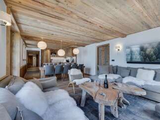 This stunning chalet boasts a spacious open-plan living area with a cozy fireplace, perfect for relaxing after a day on the slopes.