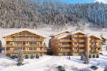 Luxury chalets nestled in a snowy mountainside, offering breathtaking views and ski-in/ski-out access.