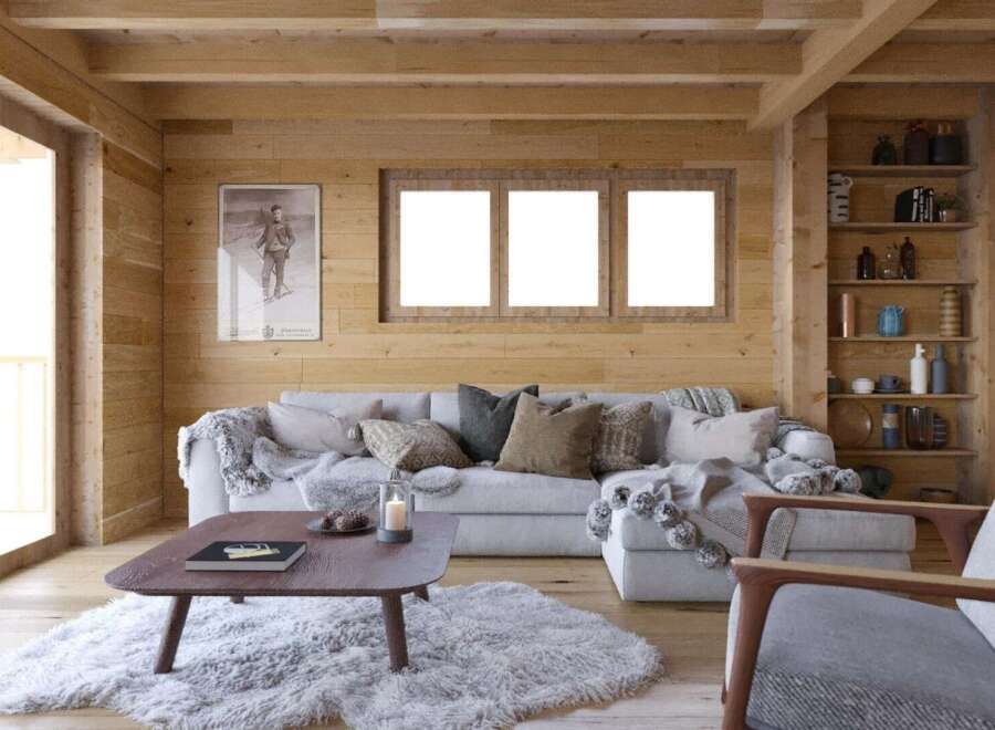 Cozy mountain cabin living room with wood-paneled walls, large windows, and a comfortable sectional sofa.