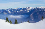 Breathtaking panoramic view of snow-capped mountains and valleys.