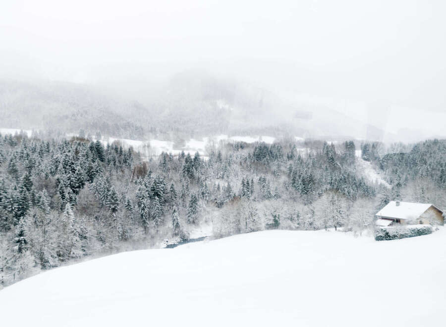 Secluded snowy mountain cabin nestled in a winter wonderland.