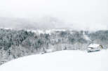 Secluded snowy mountain cabin nestled in a winter wonderland.