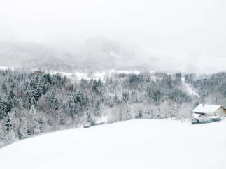 Secluded snowy mountain cabin nestled in a winter wonderland.