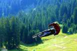 Experience the thrill of mountain biking like never before! This breathtaking image captures a rider soaring through the air, showcasing the exhilarating freedom of the sport.