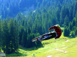 Experience the thrill of mountain biking like never before! This breathtaking image captures a rider soaring through the air, showcasing the exhilarating freedom of the sport.