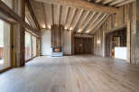 Experience rustic luxury in this stunning mountain chalet featuring a grand fireplace and exposed wooden beams.