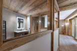 Experience rustic luxury in this stunning bathroom featuring natural wood accents and modern amenities.