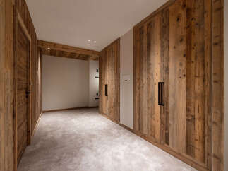 Experience rustic charm and modern convenience in this beautifully appointed room featuring custom wooden cabinetry and a plush carpeted floor.