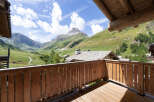 Experience breathtaking mountain views from this charming wooden balcony, perfect for enjoying your morning coffee or evening relaxation.