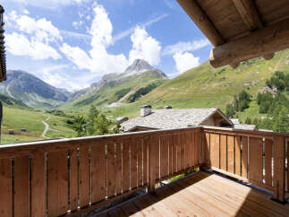 Experience breathtaking mountain views from this charming wooden balcony, perfect for enjoying your morning coffee or evening relaxation.