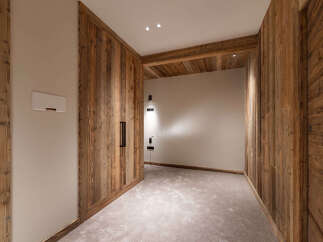 Experience rustic charm and modern comfort in this beautifully appointed room, featuring warm, natural wood paneling throughout.