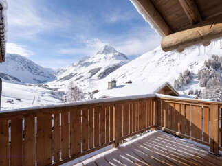 Experience breathtaking mountain views from this charming wooden balcony, perfect for enjoying your morning coffee or evening relaxation.