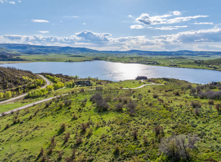Luxury lakefront property with stunning mountain views and private access road.