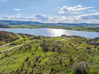 Luxury lakefront property with stunning mountain views and private access road.