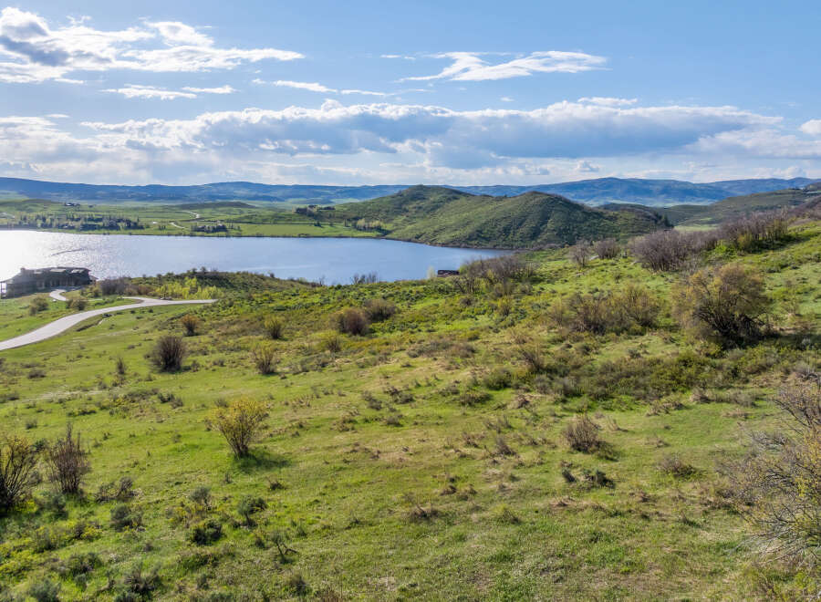 This stunning property boasts breathtaking views of a serene lake nestled in a picturesque valley.
