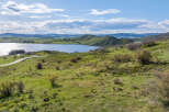 This stunning property boasts breathtaking views of a serene lake nestled in a picturesque valley.