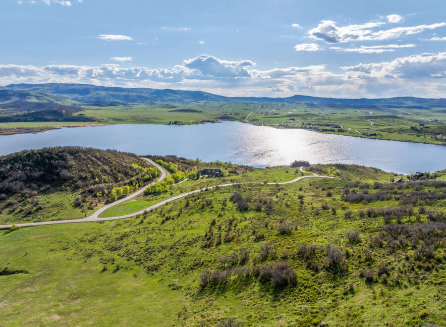 Luxury lakefront property with stunning mountain views and a private road.