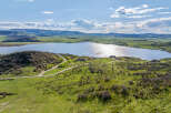 Luxury lakefront property with stunning mountain views and a private road.