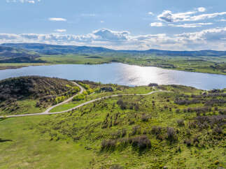 Luxury lakefront property with stunning mountain views and a private road.