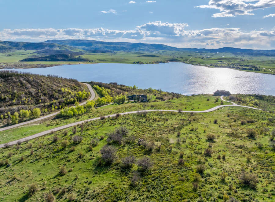 Luxury lakefront property with stunning mountain views and private road access.