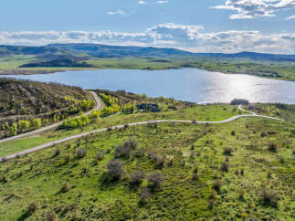 Luxury lakefront property with stunning mountain views and private road access.