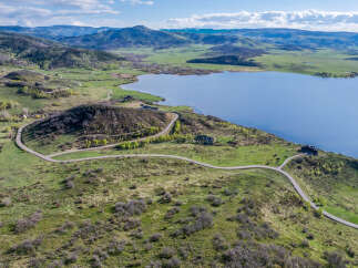 Luxury lakefront property with stunning mountain views and private road access.