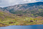 Luxury mountain homes nestled on a tranquil lake, offering breathtaking views and serene surroundings.
