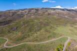 This stunning property boasts a scenic, winding road leading to breathtaking views of the mountain landscape.