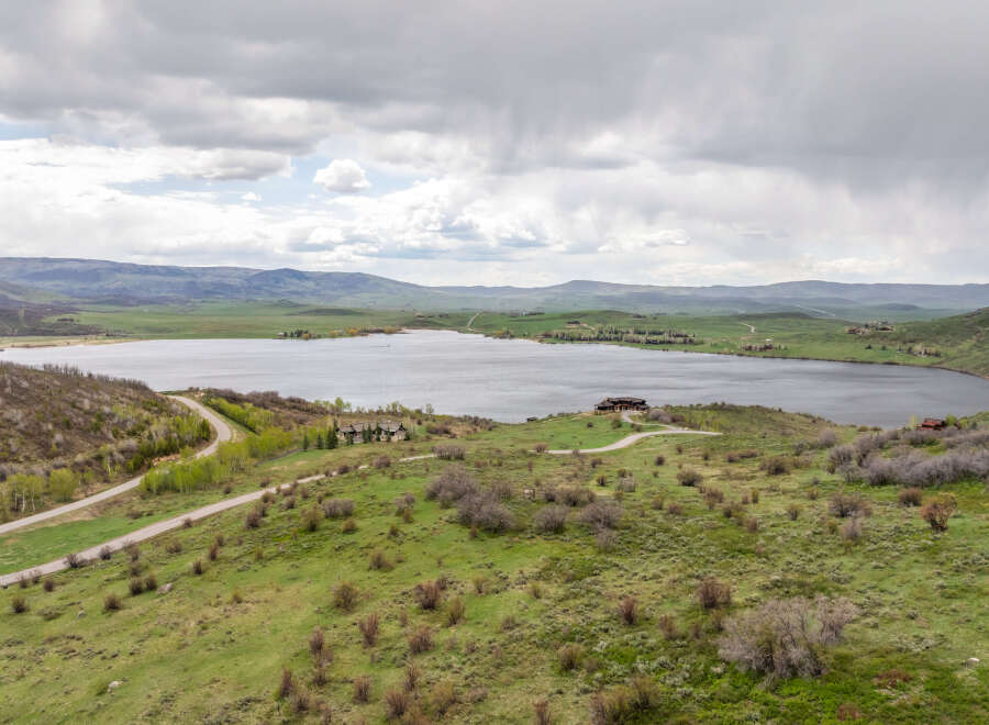 Luxury lakefront property with stunning mountain views and a private road.