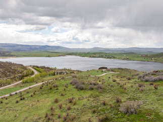 Luxury lakefront property with stunning mountain views and a private road.
