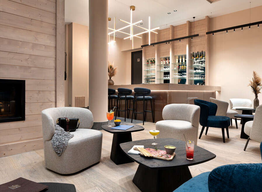 Relax in our luxurious lounge, featuring a cozy fireplace, comfortable seating, and a fully stocked bar.