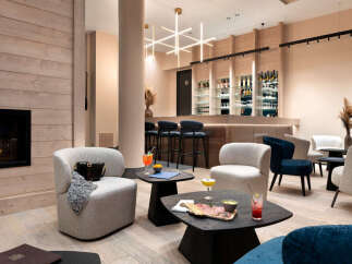 Relax in our luxurious lounge, featuring a cozy fireplace, comfortable seating, and a fully stocked bar.