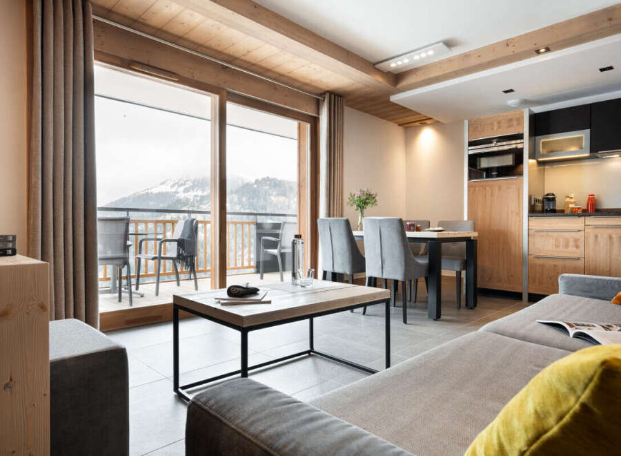 This stunning apartment boasts breathtaking mountain views from its expansive windows and private balcony.