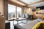 This stunning apartment boasts breathtaking mountain views from its expansive windows and private balcony.