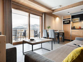 This stunning apartment boasts breathtaking mountain views from its expansive windows and private balcony.