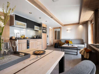 This stunning apartment boasts an open-plan living area with a modern kitchen, perfect for entertaining.