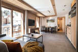 This stunning apartment boasts a spacious living area with floor-to-ceiling windows offering breathtaking mountain views, a fully equipped kitchen, and modern amenities.
